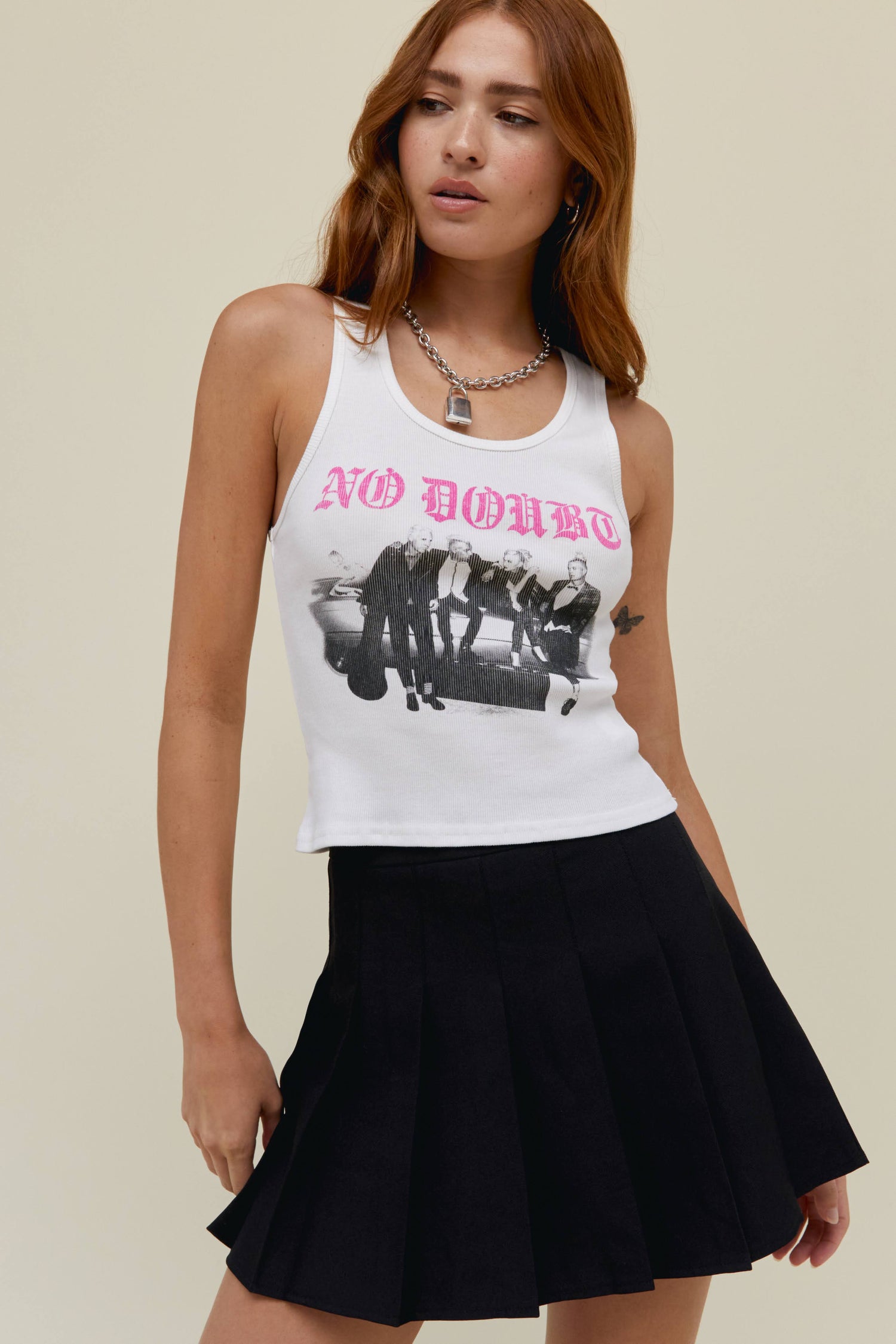 Model wearing a No Doubt graphic tank in white stamped with a rendition of No Doubt’s logo, designed with a black and white scanned portrait of the crew.