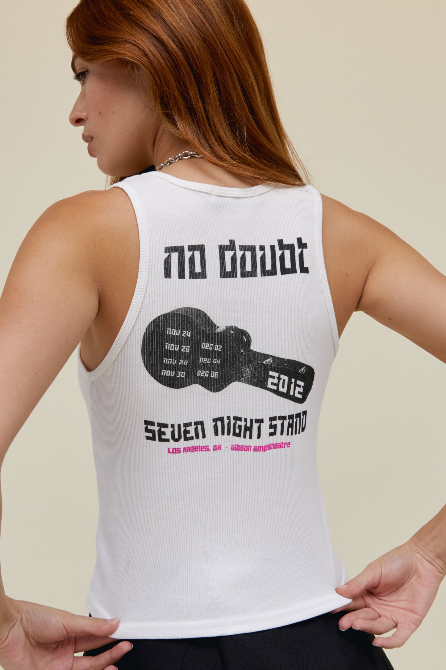 Model wearing a No Doubt graphic tank in white stamped with a rendition of No Doubt’s logo, designed with a black and white scanned portrait of the crew.