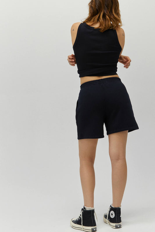 Model wearing boyfriend fit sweat shorts in black with a matching tank top.