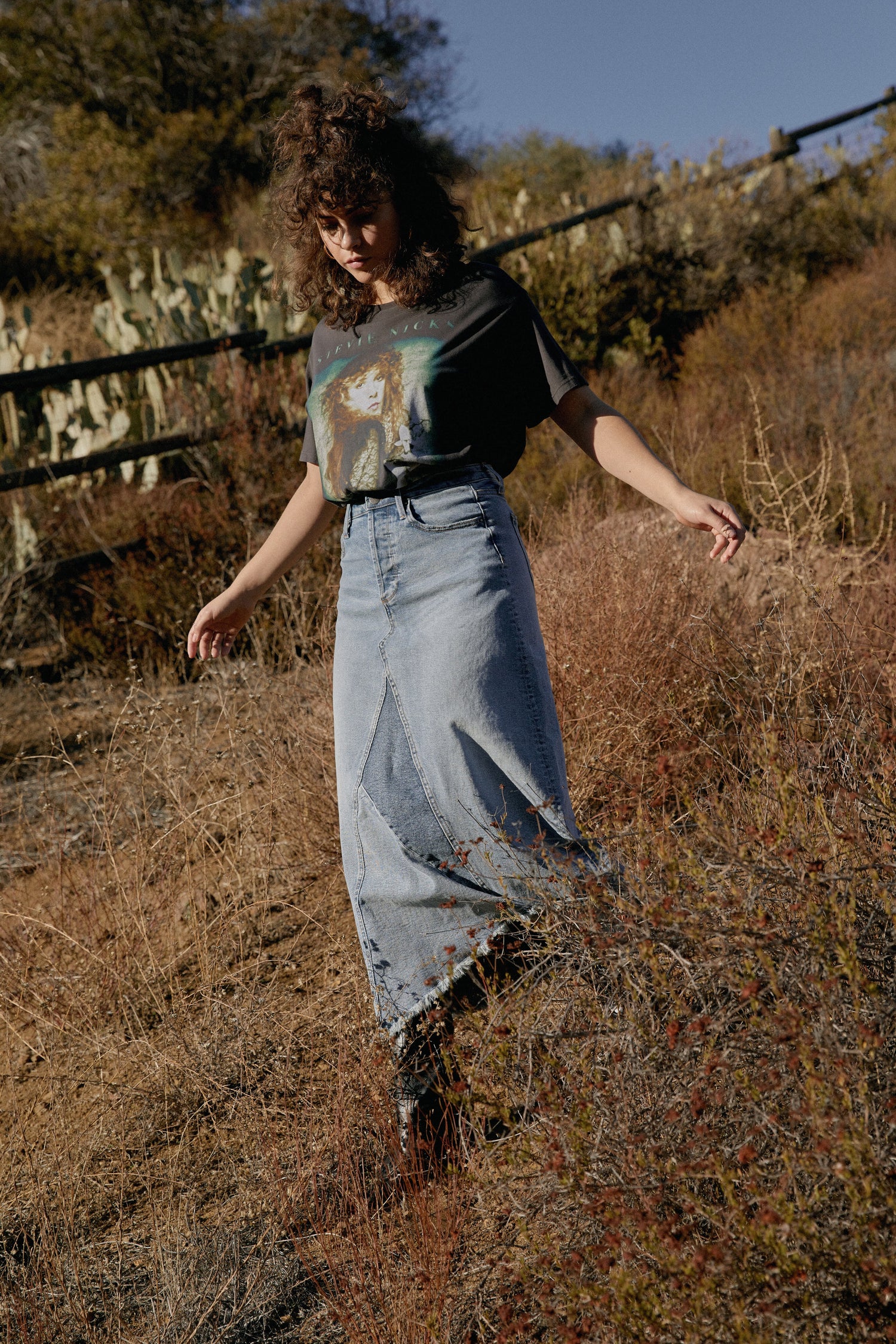 model wearing denim skirt in field