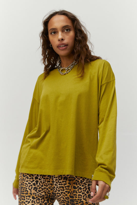 Dark-haired model featuring a green colored long slouchy sleeves