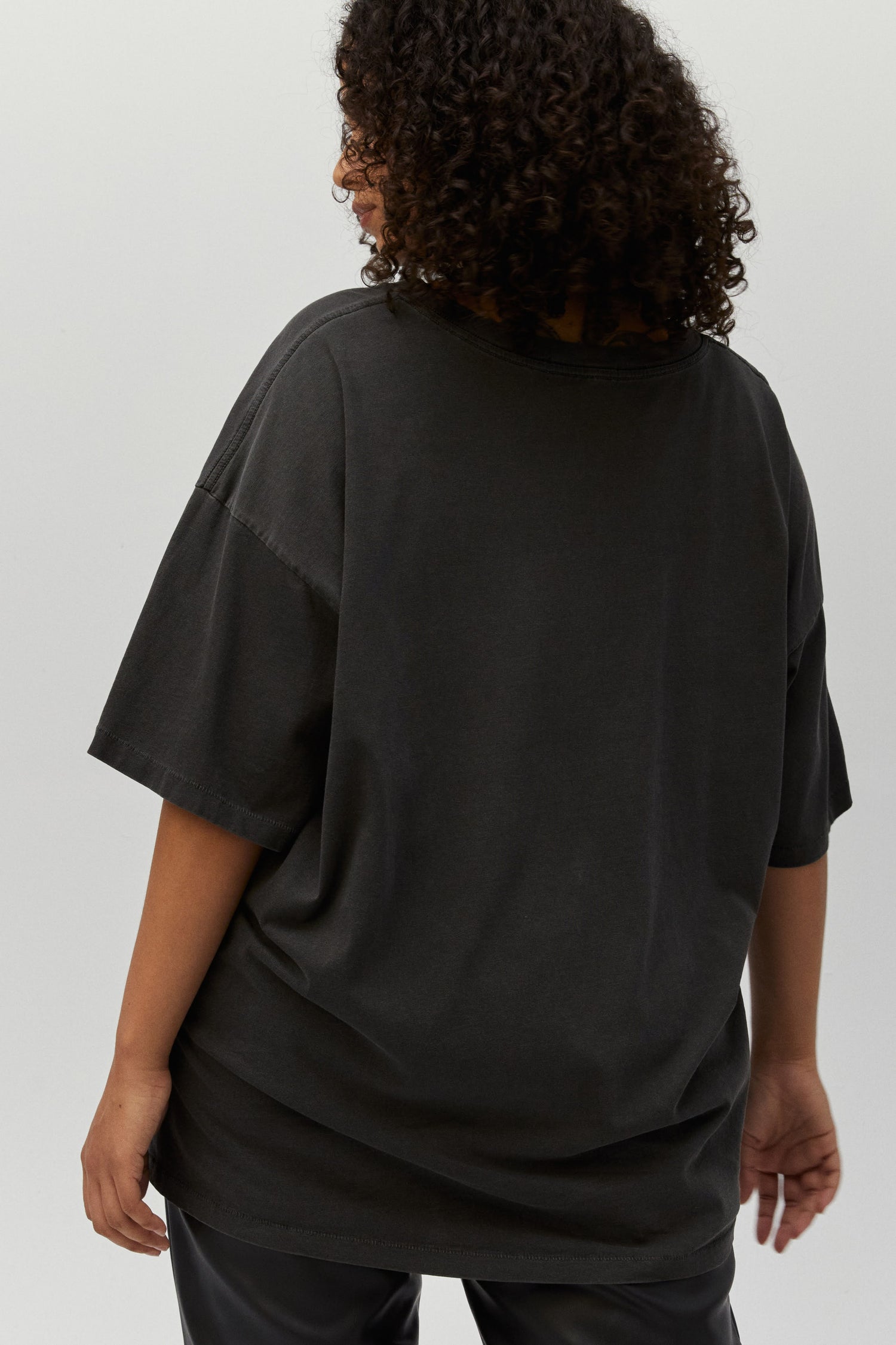 plus-size model featuring a black tee