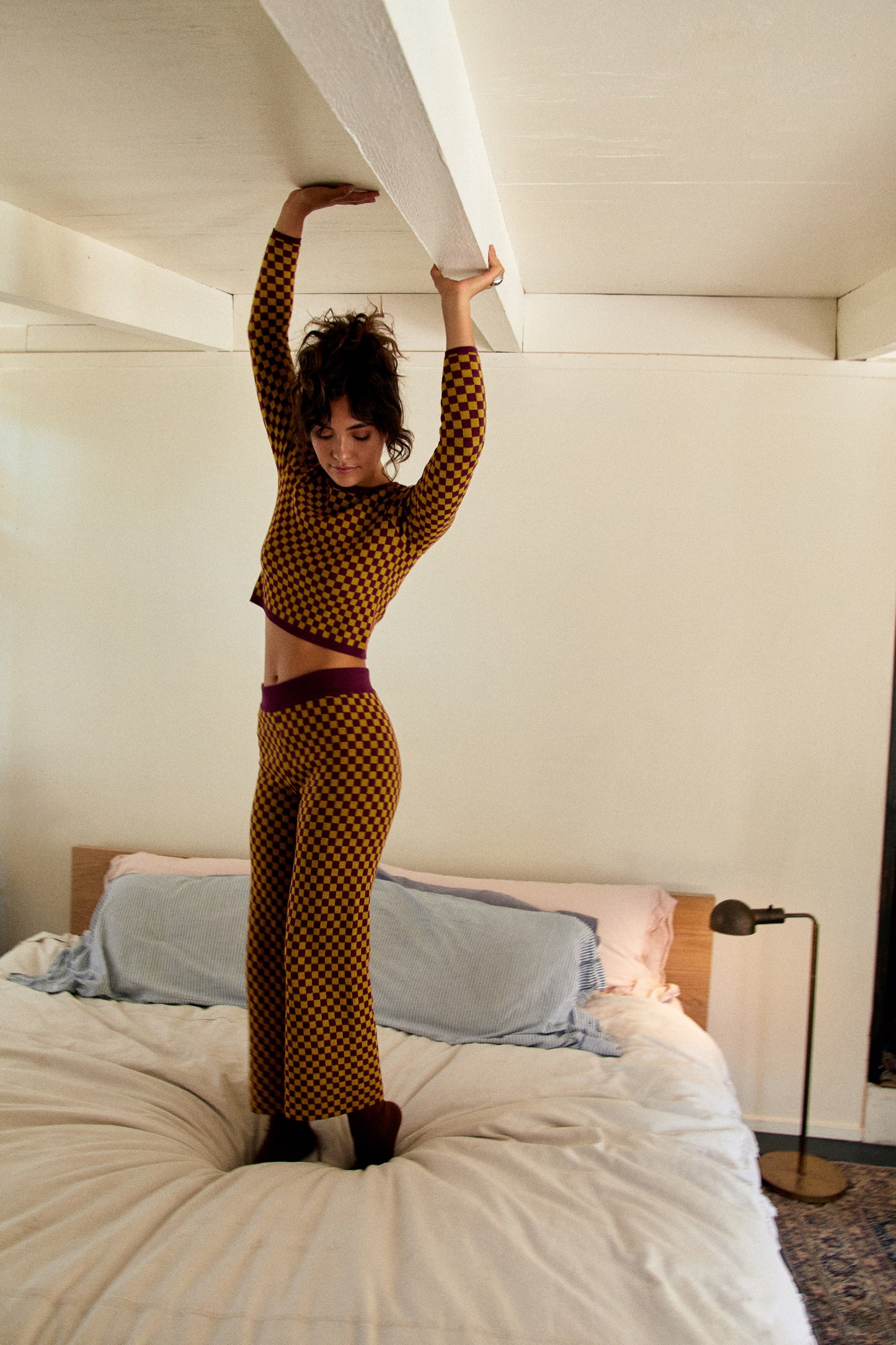 model jumping on bed