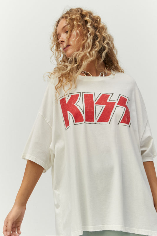 Blonde curly-haired model featuring a white tee designed with Kiss’ logo in iconic red glitter
