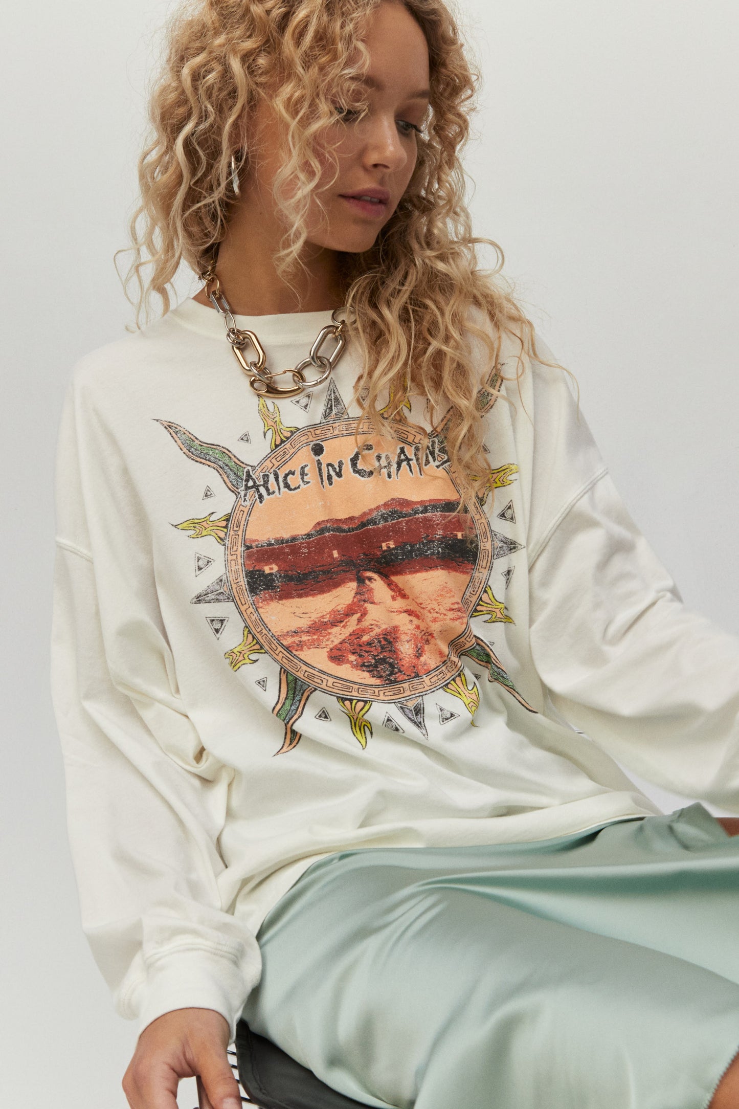 Blonde curly hair model featuring white long sleeved one size top withrendition of the Dirt album’s artwork on this billowy long sleeve. Hand drawn rustic sun with "Dirt" on the back.