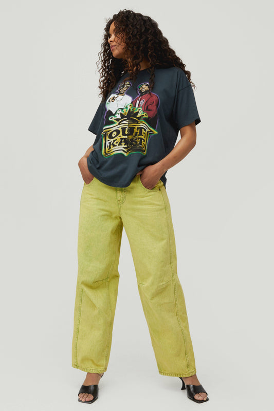 Dark curly-haired model wearing a black tee designed with the boy's center chest and ATLiens featured on the back