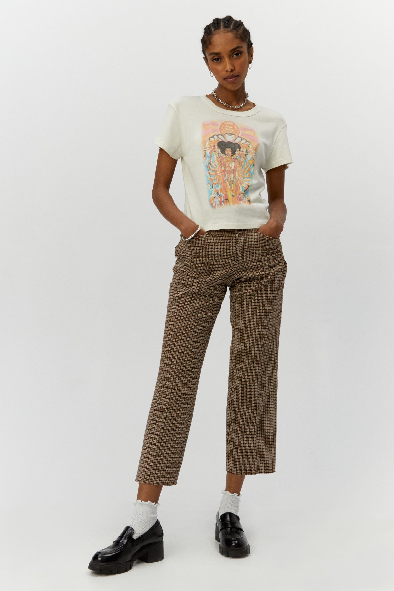 Dark braided-haired model featuring a white shrunken tee designed with a distressed rendition of the album cover’s original artwork