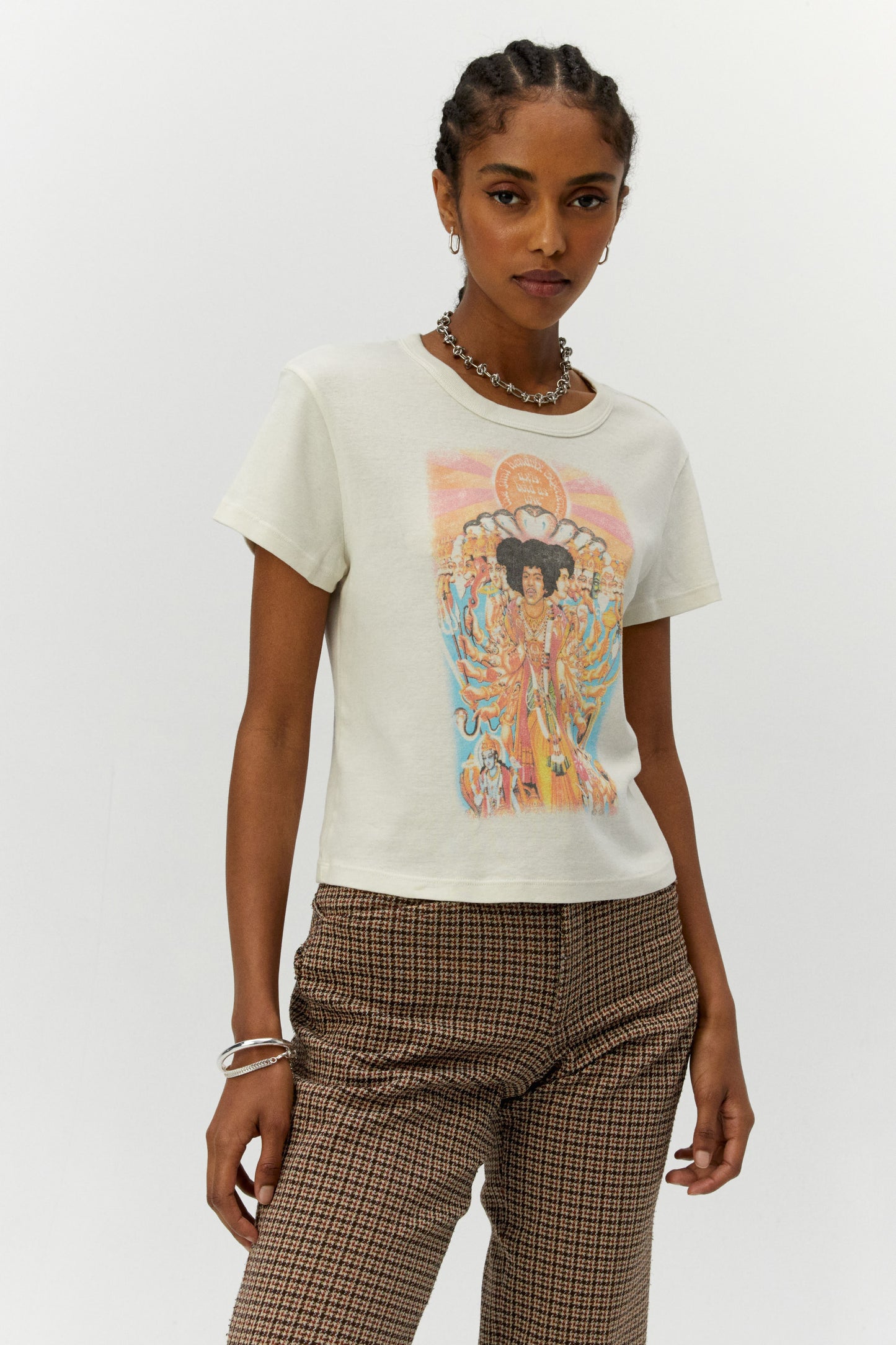 Dark braided-haired model featuring a white shrunken tee designed with a distressed rendition of the album cover’s original artwork